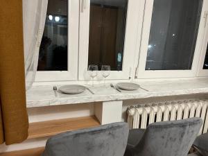 a table with two wine glasses and two chairs at :: Apartment City Center :: in Warsaw