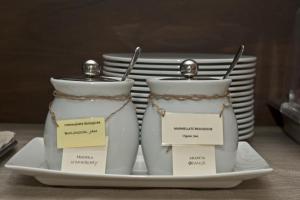 two salt and pepper shakers sitting on a plate at Nascar Hotel in Santa Maria Navarrese