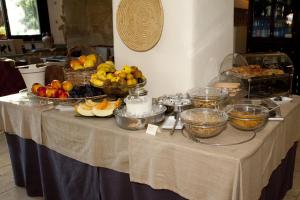 a table with bowls of fruit and other food on it at Nascar Hotel in Santa Maria Navarrese