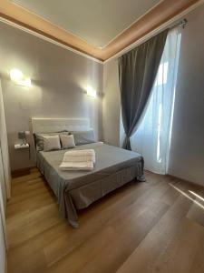 a bedroom with a bed and a large window at Piccola Dimora B&B in Lucca