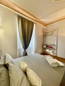 a bedroom with a large bed with a window at Piccola Dimora B&B in Lucca