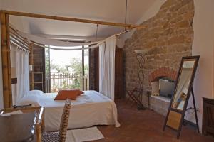 a bedroom with a bed and a stone wall at Nascar Hotel in Santa Maria Navarrese