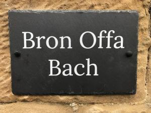 a sign that reads born offa beach on a wall at Escape To The Country @ Bron Offa Bach in Coedpoeth