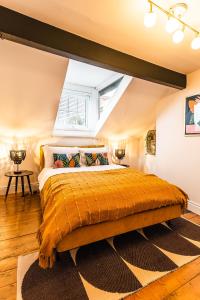 a bedroom with a large bed in a attic at The Crescent Townhouse in Lisburn