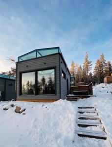 a modern house in the snow with a glass roof at Arctic Iglu Levi in Sirkka