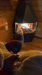 una copa de vino junto a la chimenea en Cabanas rota da neve, en Urubici