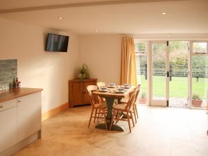 a kitchen and dining room with a table and chairs at Robins Nest - Uk40747 in Coddington