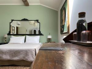a bedroom with a bed and a large mirror at BLQ 01boutique B&B in Bologna