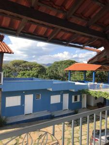 a blue building with a view from a balcony at Pousada Trilha do Sol in Pirenópolis
