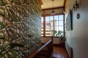a hallway with a large plant on the wall at Gervasoni Hotel Boutique in Valparaíso