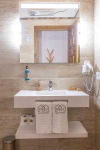 a bathroom with a sink and a mirror at ANJ Alojamientos in Guadalupe +80 photos