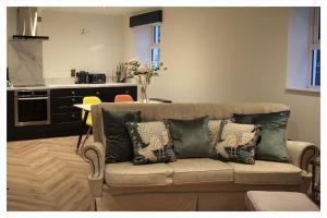 a living room with a couch with pillows on it at Killeavy Cottage in Meigh