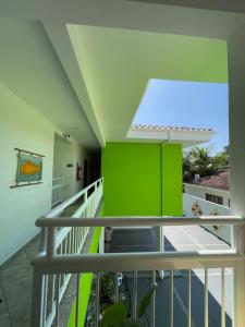 a view from the balcony of a building with a green wall at Pousada Serrate in Ubatuba