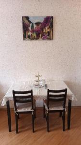 a white table with two chairs and a cross on it at Gold Baku in Baku