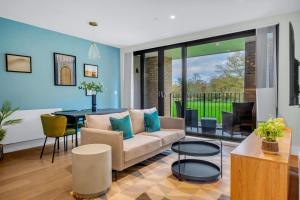 a living room with a couch and a table at Be London - The London Residences in London