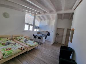 a room with two beds and a desk in it at Bellinzona Rooms in Bellinzona