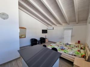 a room with a table and a bed in it at Bellinzona Rooms in Bellinzona