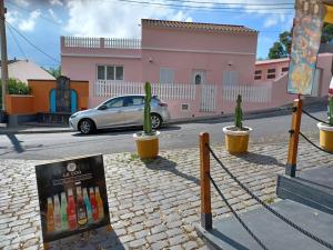 a car driving down a street with a sign on the street at Casa da Ribeira - Mosteiros in Mosteiros