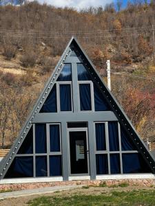 a house with a triangular roof with windows at Green Villa Resort Blue in Dilijan