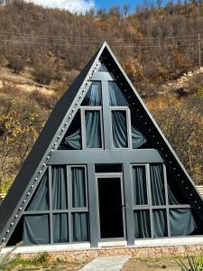 a triangular house with windows in a field at Green Villa Resort Grey in Dilijan