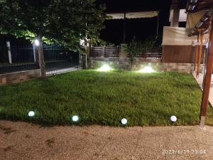 a group of golf balls on the grass at night at Verde Home in Nea Mesangala
