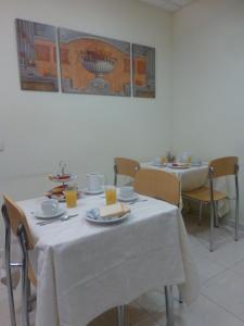 a table topped with plates and bowls of food at Hostal El Val in Alcalá de Henares