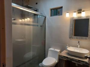 a bathroom with a toilet and a sink and a shower at Privacidad y comodidad in Los Mochis