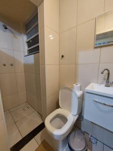 a small bathroom with a toilet and a sink at Pousada Cantinho da Família in Rio de Janeiro