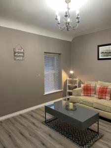 a living room with a couch and a coffee table at Heights View Apartment in Derry Londonderry