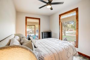 a bedroom with a bed and a ceiling fan at Marble Falls Zen in Marble Falls