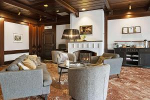 a living room with couches and a fireplace at Best Western Nya Star Hotel in Avesta