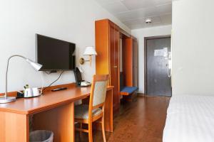 a hotel room with a desk with a computer on it at Best Western Nya Star Hotel in Avesta