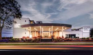 a large white building with lights on it at Arawa Park Hotel, Independent Collection by EVT in Rotorua