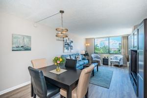 a dining room and living room with a table and chairs at Palma Fabulous Island View Condo in St Petersburg