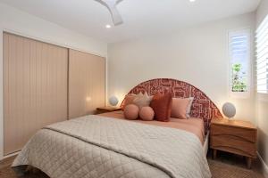 a bedroom with a large bed with pillows on it at Aquarius Apartment 9 in Hawks Nest