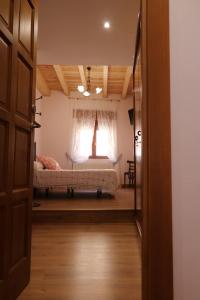 a view of a bedroom with a bed and a window at los arcos y ancasela in Santa María del Campo