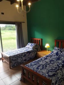 Postel nebo postele na pokoji v ubytování CABAÑAS EXCLUSIVAS LAS ROSAS - CORDOBA