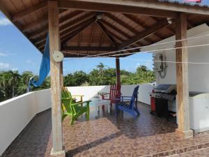 a view from the balcony of a house with a table and chairs at CortLang - Beach Apartments - in El Pueblito near Playa Dorada in San Felipe de Puerto Plata
