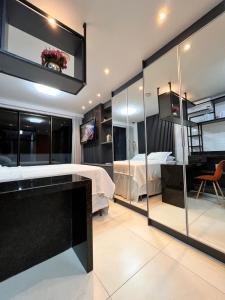 a bedroom with a bed and a tv in a room at » MODERNO E ACONCHEGANTE FLAT COM VARANDA « in João Pessoa