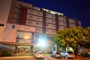 a tall building with cars parked in front of it at Hotel Serra Grande - SERRA - ES in Serra