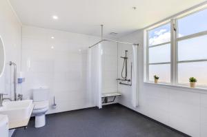 a bathroom with a toilet and a sink and a window at Lake Maraetai Lodge in Mangakino +23 photos