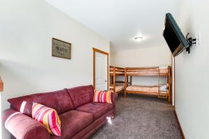 a living room with a couch and a bunk bed at Log Into Vacation Mode in Ronald