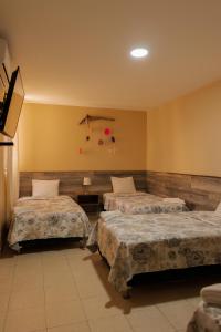 Cama ou camas em um quarto em Hotel El Huacachinero