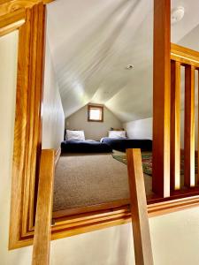 a bedroom with two beds in a attic at Lexi's Lodge in Lake Tekapo