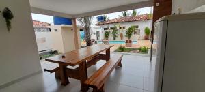 einen Holztisch in einer Küche mit Blick auf den Innenhof in der Unterkunft Casa com Piscina em Guaratiba in Prado