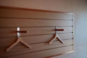 a close up of two wooden doors with hangers at ritomaru house iki ashibe in Iki