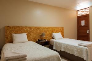 Cama ou camas em um quarto em Hotel El Huacachinero