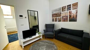 a living room with a couch and a television at OneLuxStay near Fashion District in Antwerp