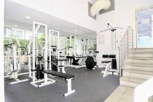 a gym with treadmills and machines in a room at City skyline views with swimming pool! in Melbourne