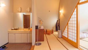a bathroom with a sink and a mirror at Hakuba Sun Valley Hotel Annex in Hakuba